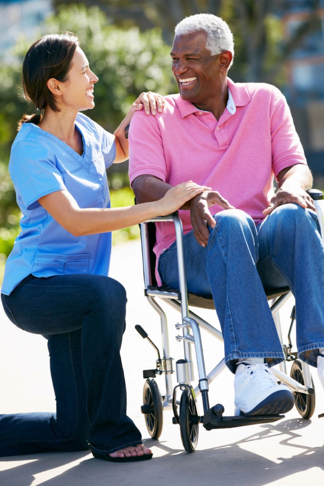 Caregiver with elderly patient smiling